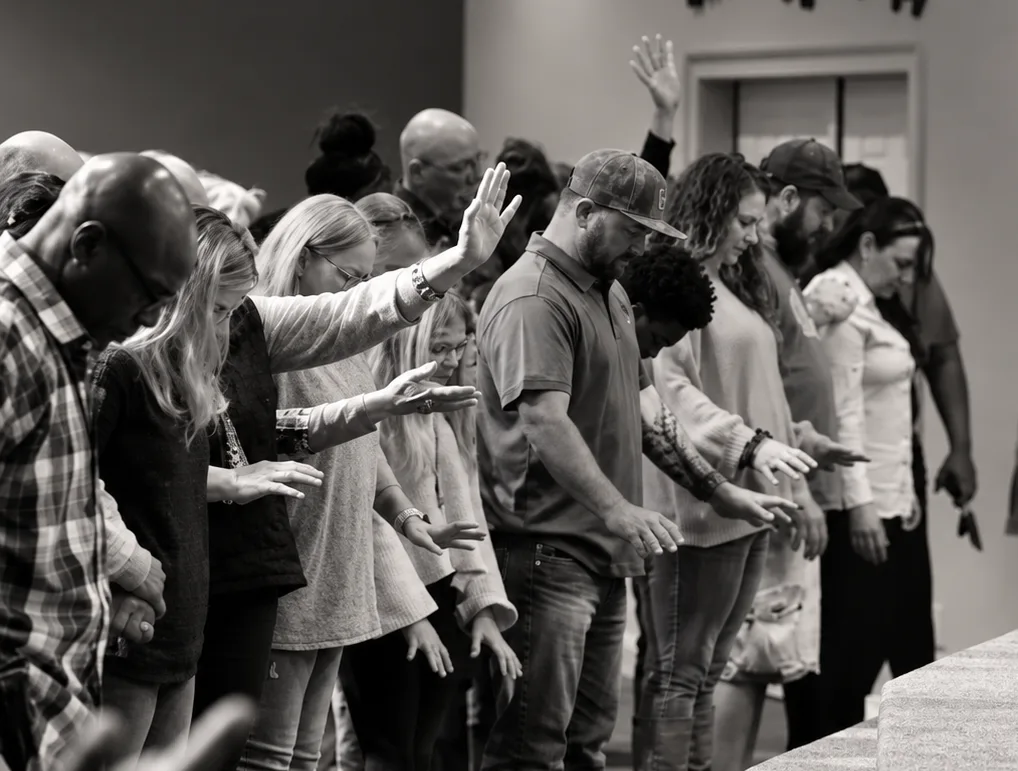 Congregation worshipping with hands raised