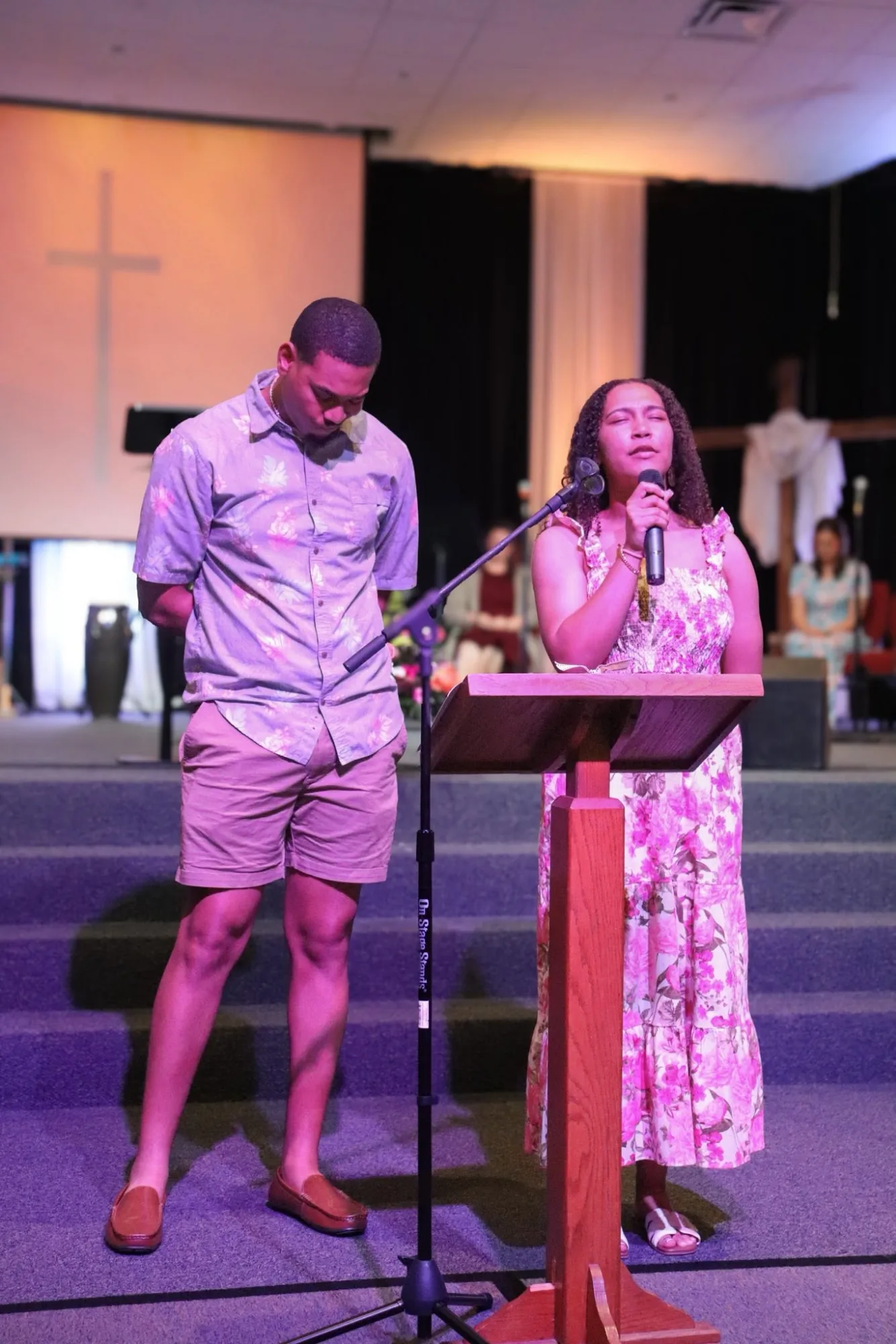 Young adults praying during service